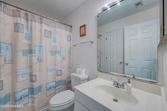 bathroom featuring visible vents, curtained shower, toilet, and vanity