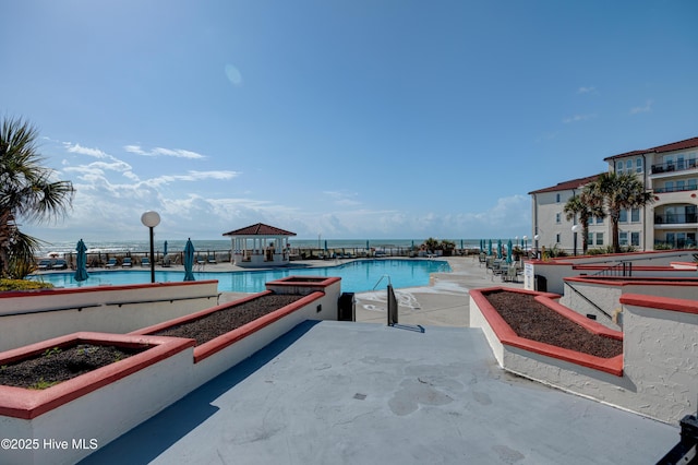 pool with a gazebo and a patio