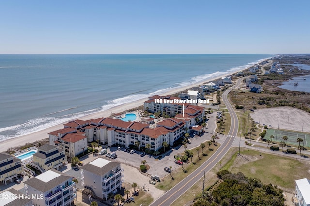 birds eye view of property featuring a water view and a view of the beach