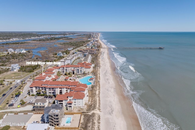 bird's eye view featuring a view of the beach and a water view