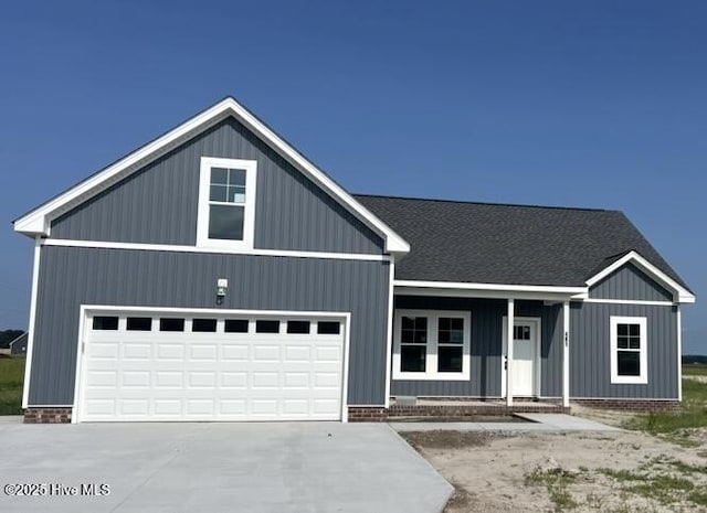 481 N Trotman Rd, Camden, NC 27921 - view of front of property featuring a porch, a garage, concrete driveway, and roof with shingles