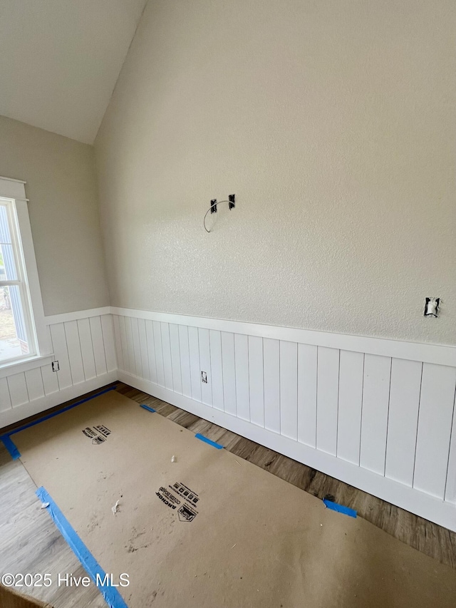 481 N Trotman Rd, Camden, NC 27921 - unfurnished room with a wainscoted wall, wood finished floors, and vaulted ceiling