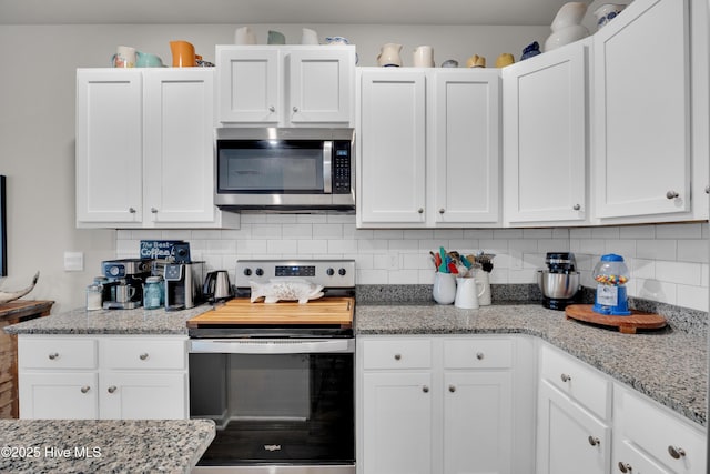 3659 Roseblossom Dr, Leland, NC 28451 - kitchen with tasteful backsplash, white cabinets, stainless steel appliances, and light stone counters