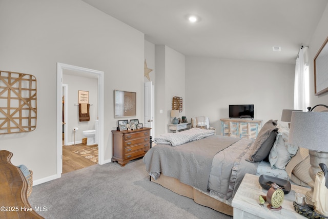 3659 Roseblossom Dr, Leland, NC 28451 - carpeted bedroom featuring baseboards, ensuite bath, and vaulted ceiling