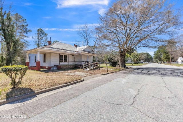 901 Daughtridge St, Rocky Mount, NC 27801 - farmhouse inspired home with asphalt driveway, covered porch, and a chimney