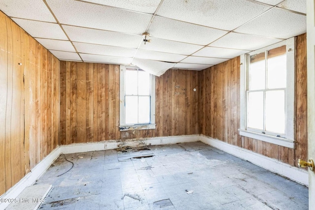 901 Daughtridge St, Rocky Mount, NC 27801 - spare room featuring a drop ceiling, wood walls, and baseboards
