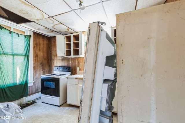 901 Daughtridge St, Rocky Mount, NC 27801 - kitchen featuring white range with electric stovetop, wood walls, white cabinetry, a paneled ceiling, and tile countertops