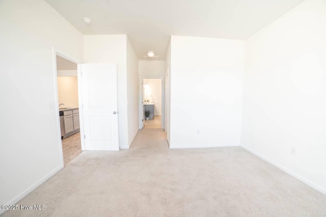 unfurnished bedroom with baseboards and light colored carpet