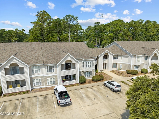 405 Commerce Ave Unit A, Morehead City, NC 28557 - view of front of house with a shingled roof and uncovered parking
