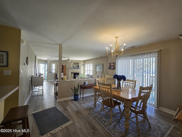405 Commerce Ave Unit A, Morehead City, NC 28557 - dining area with baseboards, a fireplace, ceiling fan with notable chandelier, and wood finished floors