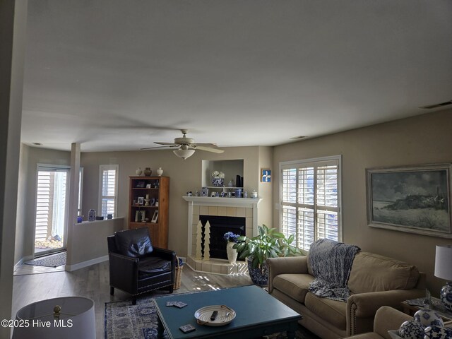 405 Commerce Ave Unit A, Morehead City, NC 28557 - living room with visible vents, wood finished floors, a wealth of natural light, and a fireplace