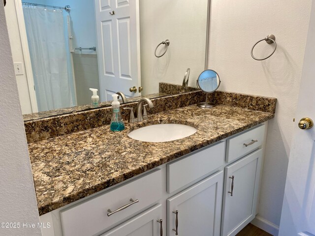 bathroom with vanity and a shower with curtain
