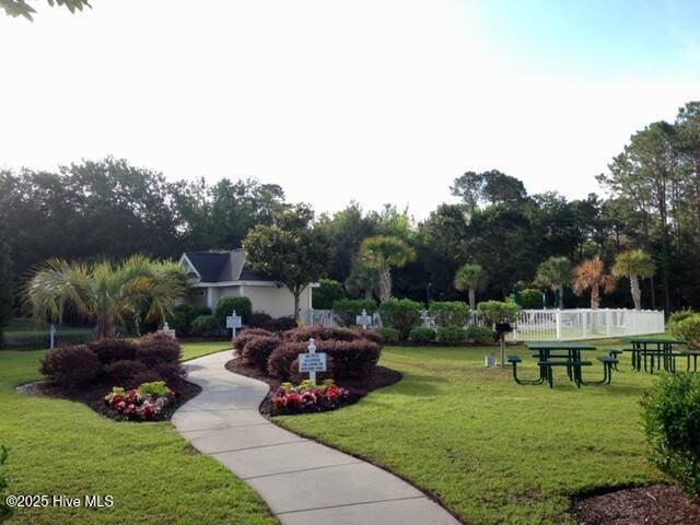 surrounding community with a lawn and fence