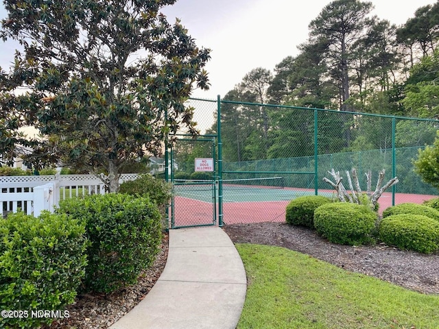 view of sport court with fence and a gate