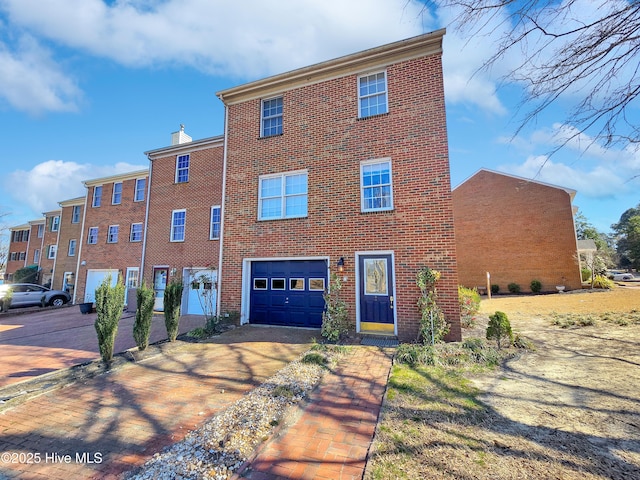 view of front of property featuring driveway, an attached garage, and brick siding