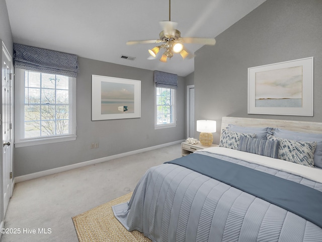bedroom featuring visible vents, baseboards, a ceiling fan, light carpet, and lofted ceiling