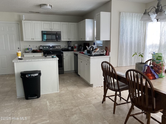 1008 S 10th St, Wilmington, NC 28401 - kitchen featuring stainless steel electric range oven, dishwasher, light countertops, a chandelier, and white cabinets