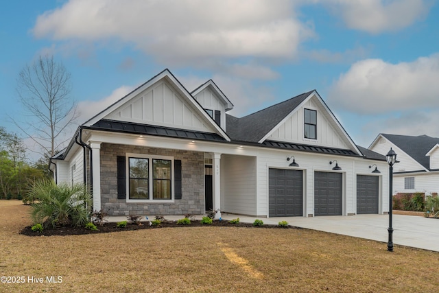 modern farmhouse style home featuring a standing seam roof, board and batten siding, a front yard, an attached garage, and metal roof