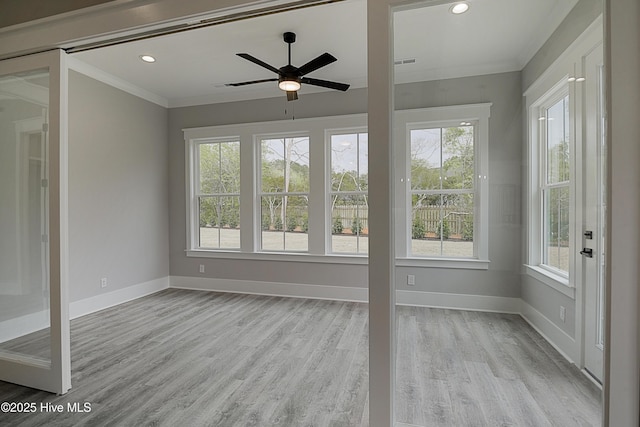 unfurnished sunroom featuring a ceiling fan and visible vents