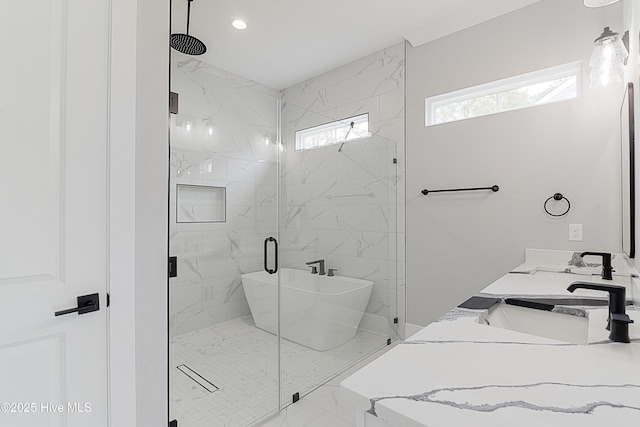 bathroom with a marble finish shower, double vanity, recessed lighting, a sink, and marble finish floor