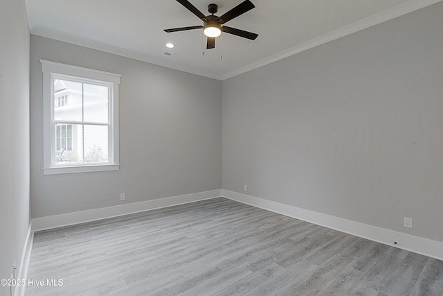 empty room with ceiling fan, baseboards, and ornamental molding