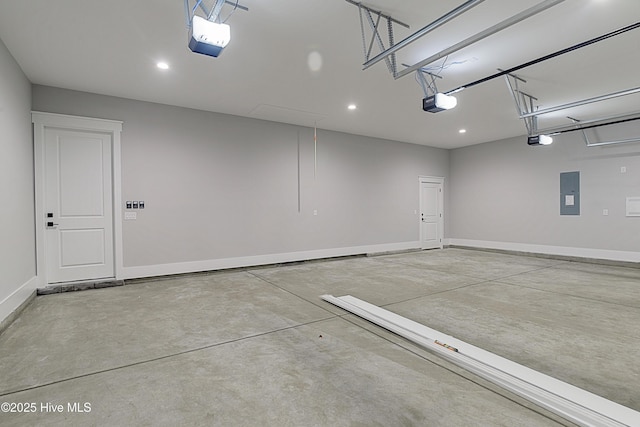 garage with electric panel, a garage door opener, and baseboards