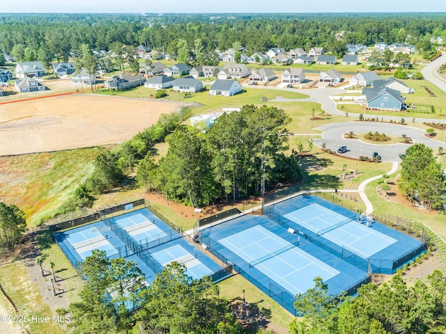 drone / aerial view featuring a forest view and a residential view