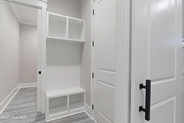 mudroom featuring baseboards and wood finished floors