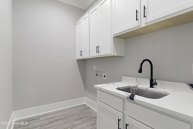 laundry area featuring baseboards, washer hookup, cabinet space, hookup for an electric dryer, and a sink