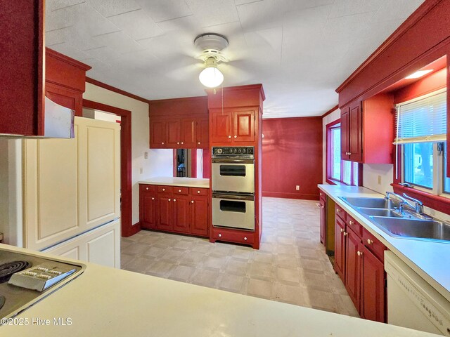 203 Crescent Dr, Windsor, NC 27983 - kitchen with light flooring, reddish brown cabinets, baseboards, a chandelier, and ornamental molding