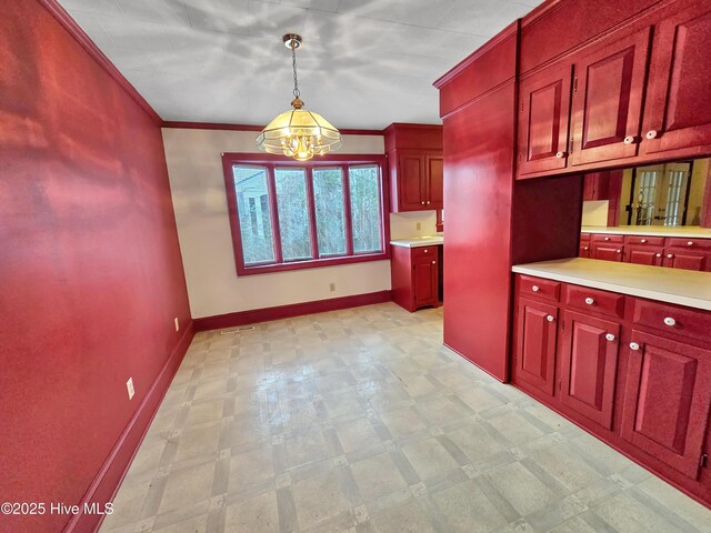 203 Crescent Dr, Windsor, NC 27983 - kitchen featuring baseboards, dark brown cabinets, light floors, light countertops, and hanging light fixtures