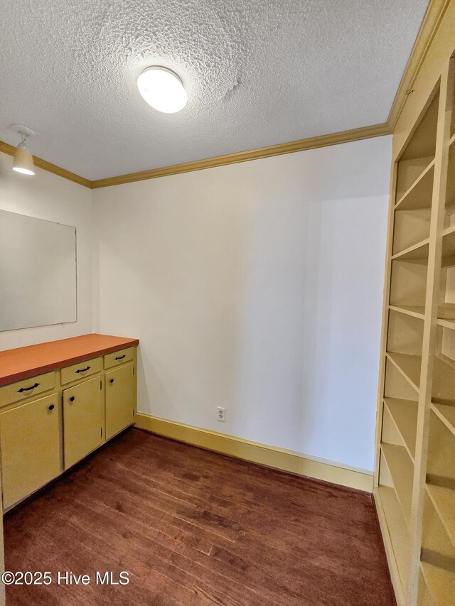 203 Crescent Dr, Windsor, NC 27983 - unfurnished bedroom with wood finished floors, a textured ceiling, baseboards, ornamental molding, and a closet