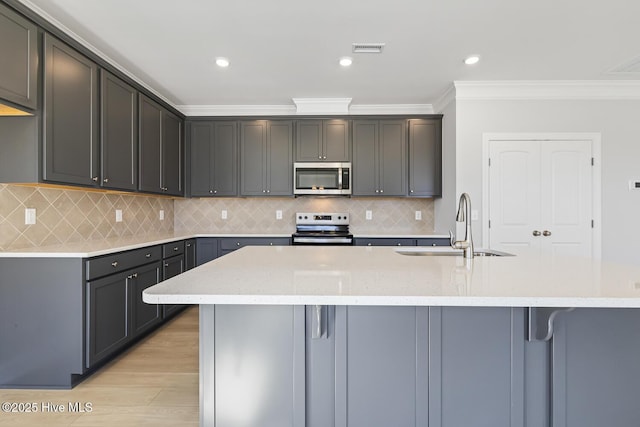 3700 Cessna Way W, Wilson, NC 27896 - kitchen featuring stainless steel appliances, a sink, crown molding, light stone countertops, and light wood-style floors