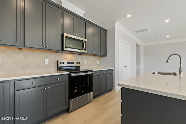 3700 Cessna Way W, Wilson, NC 27896 - kitchen featuring stainless steel appliances, crown molding, a sink, light wood finished floors, and tasteful backsplash
