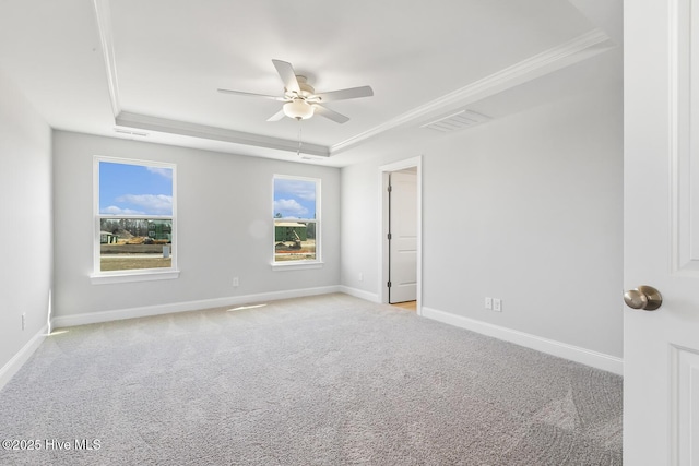 3700 Cessna Way W, Wilson, NC 27896 - empty room with a raised ceiling, a ceiling fan, light colored carpet, crown molding, and baseboards