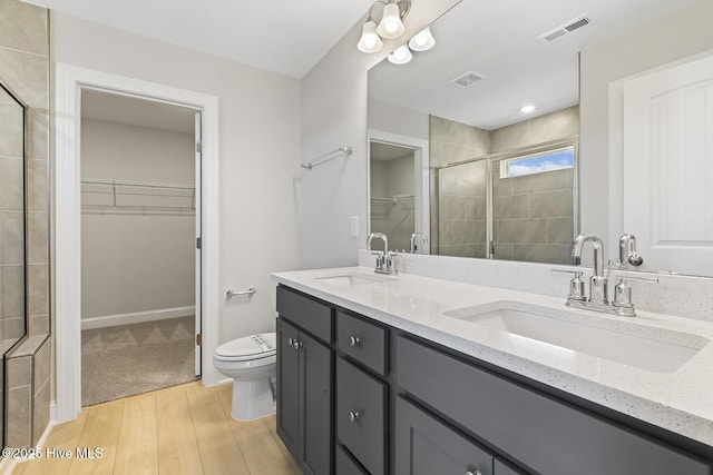 3700 Cessna Way W, Wilson, NC 27896 - bathroom with a spacious closet, toilet, double vanity, wood finished floors, and a shower stall