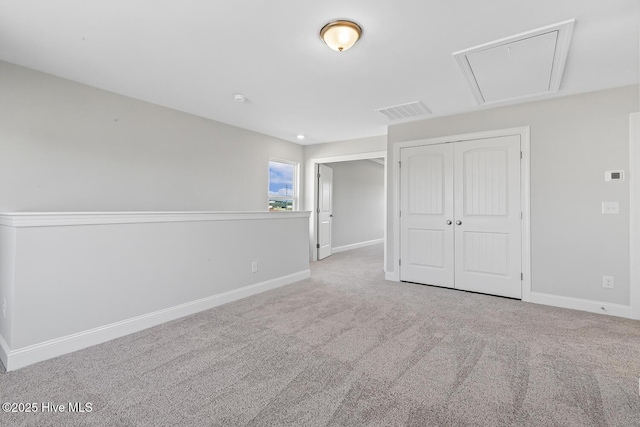 3700 Cessna Way W, Wilson, NC 27896 - unfurnished bedroom featuring attic access, carpet floors, baseboards, and a closet