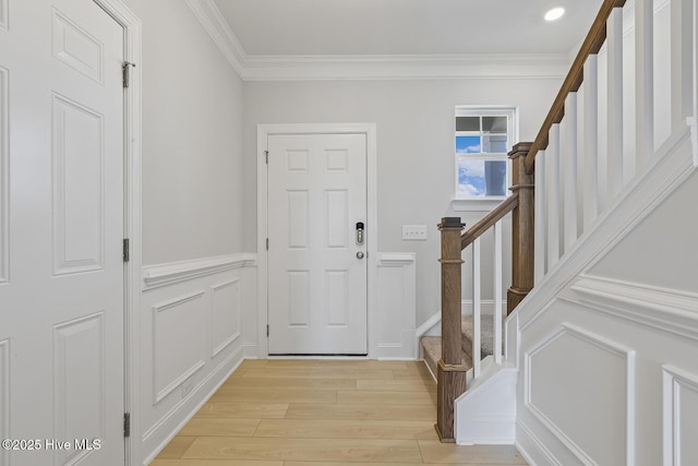 3700 Cessna Way W, Wilson, NC 27896 - entrance foyer with crown molding, light wood finished floors, stairs, a decorative wall, and a wainscoted wall