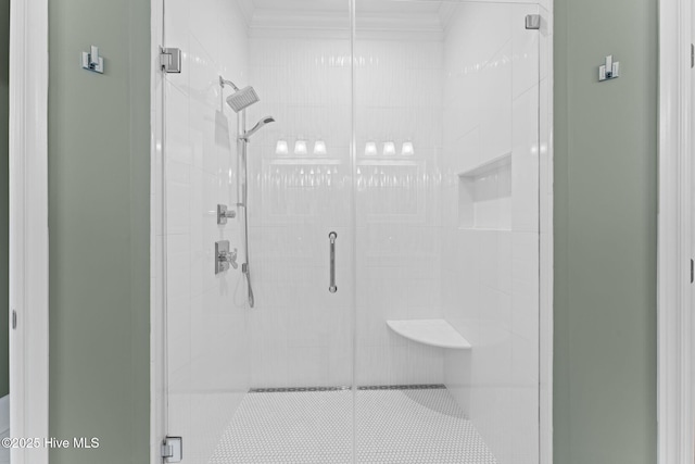 bathroom featuring a shower stall and ornamental molding