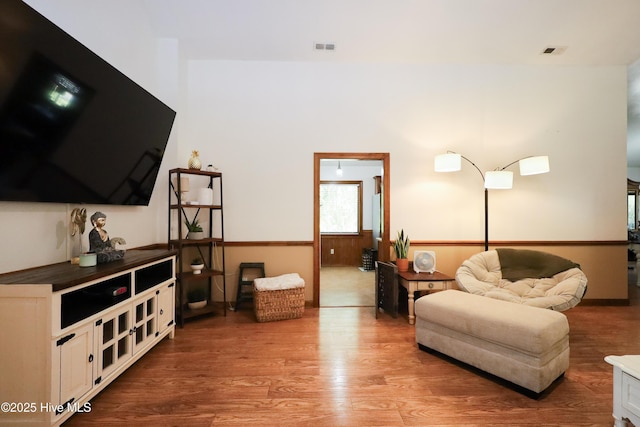 living area with light wood-type flooring and visible vents