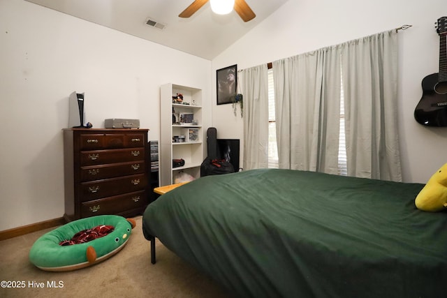 bedroom with a ceiling fan, vaulted ceiling, carpet floors, and visible vents