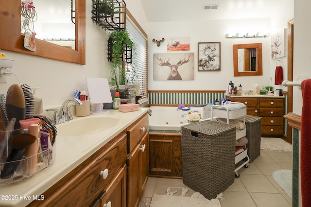 full bath with vanity, tile patterned floors, visible vents, and a jetted tub