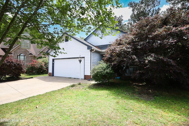 view of side of home with a garage, a lawn, and concrete driveway