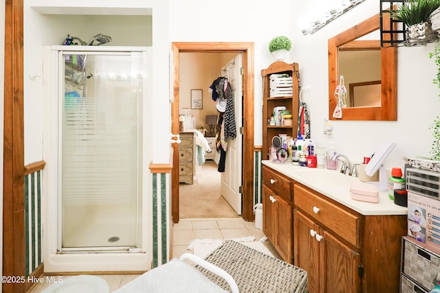 bathroom with a shower stall, tile patterned flooring, and vanity