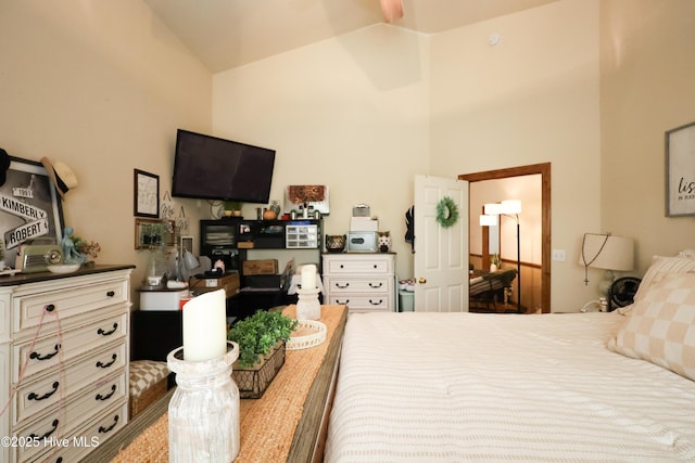 bedroom with high vaulted ceiling