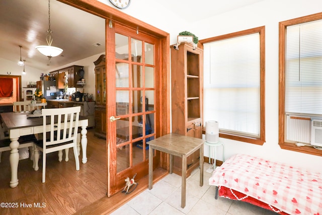 dining room featuring vaulted ceiling and light tile patterned floors
