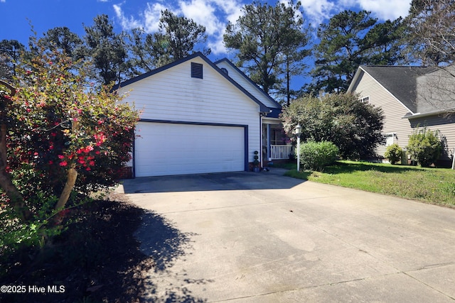 view of front of home with an attached garage, a front lawn, and driveway