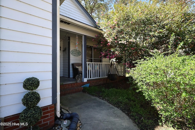 view of exterior entry with covered porch