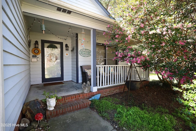 property entrance featuring covered porch