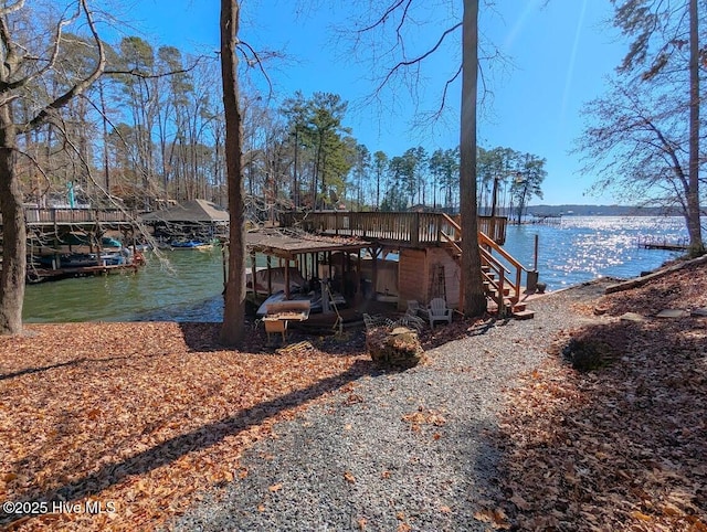 dock area featuring stairs and a water view